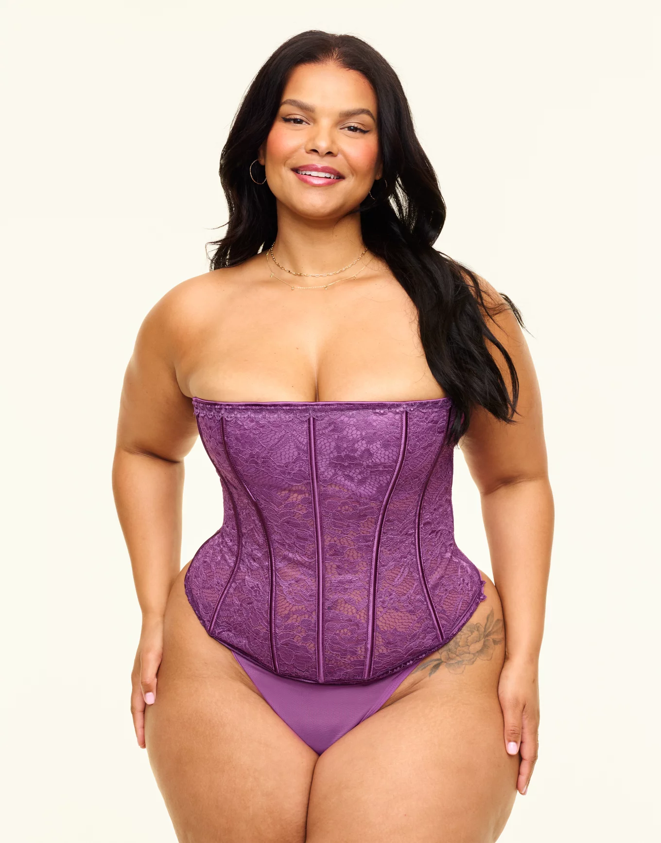 woman wearing a purple corset from Adore Me as a boudoir outfit for plus size 