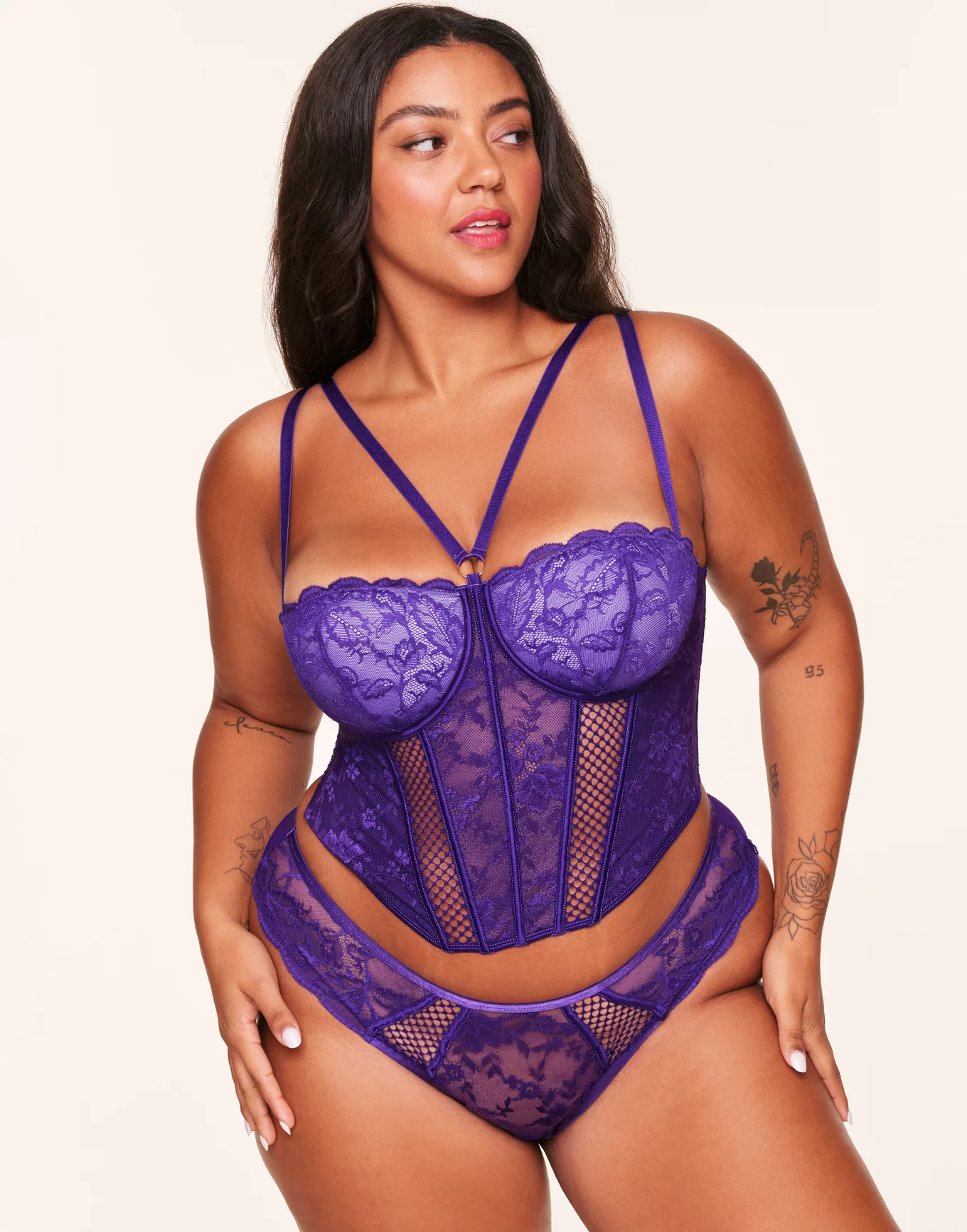 curvy woman wearing a purple corset boudoir outfit