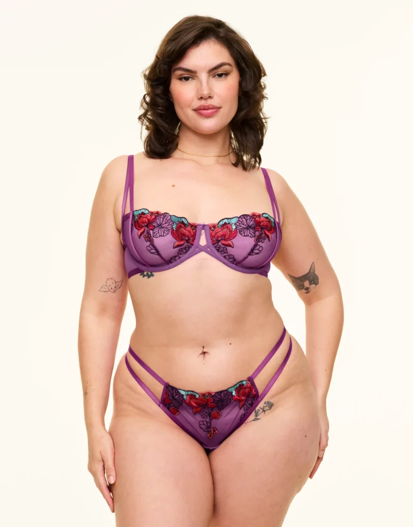 Curvy brunette woman in a matching bra and panty from Adore Me