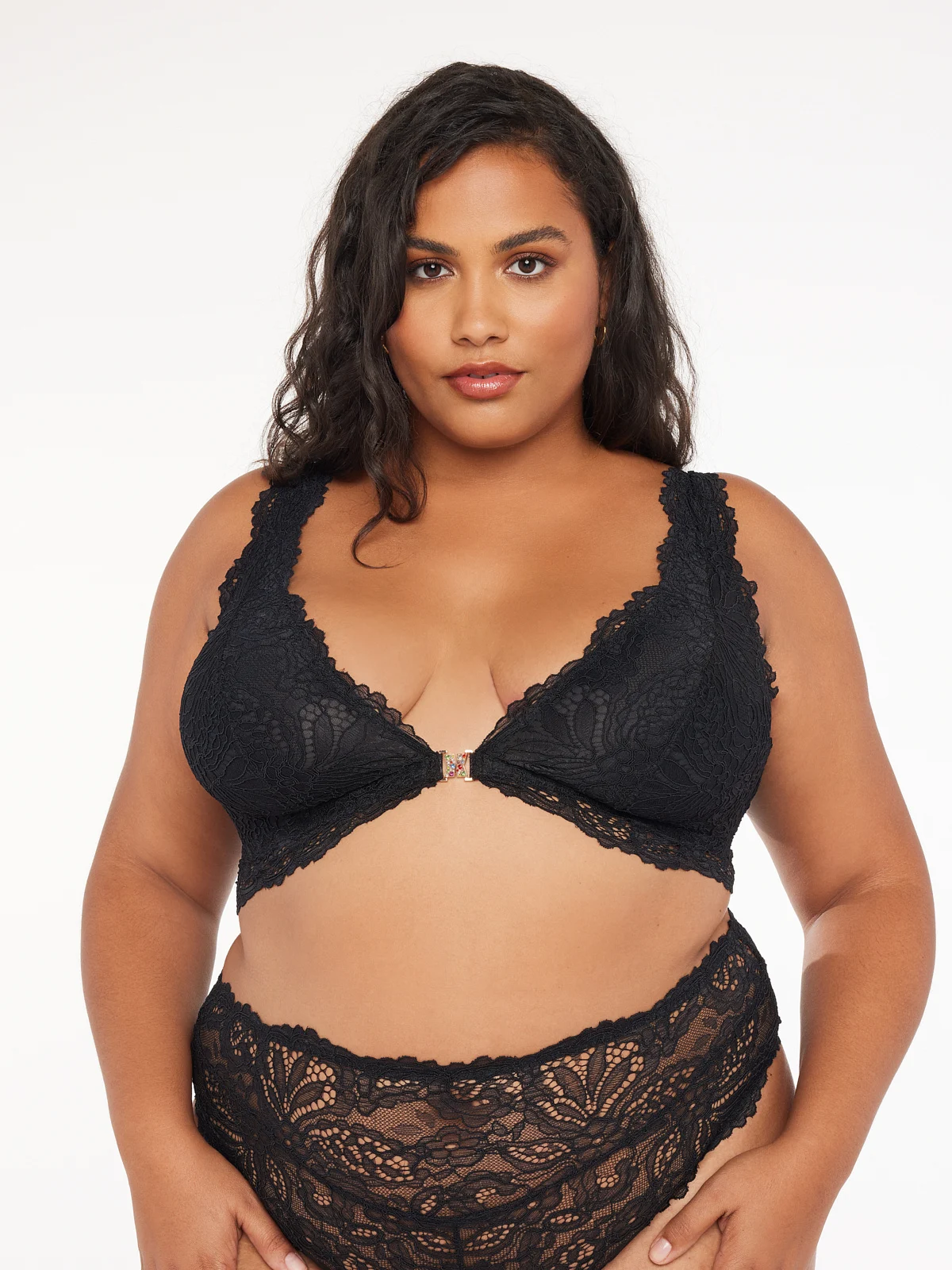 woman wearing a plus size boudoir outfit. matching black bra and high waist panties